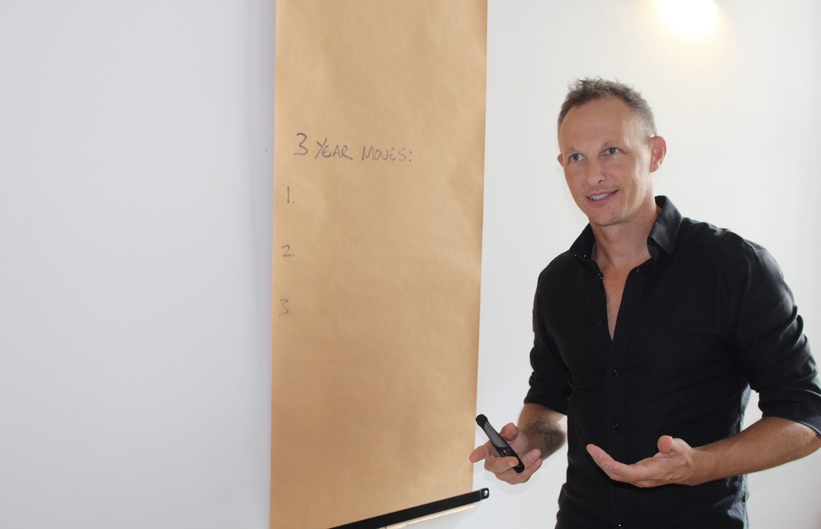 Business Coach in black shirt giving a business advisory presentation to a client